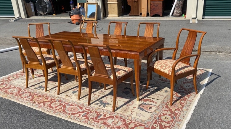 A Drexel Heritage dining set staged in front of a storage unit.