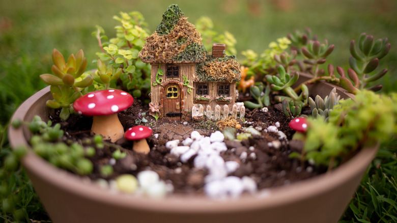 Fairy garden with mushrooms in a large plant pot.