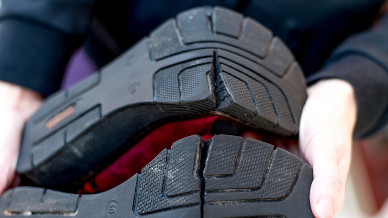 red broken shoes with cracked black sole