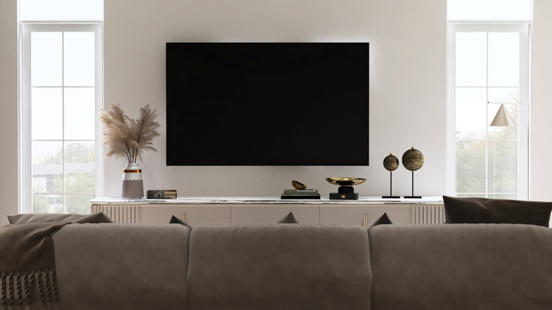 A large television screen mounted on wall in modern living room