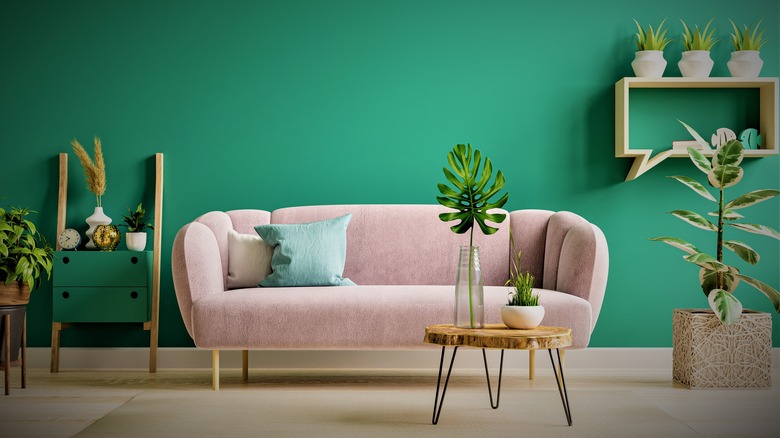 pink sofa in green room