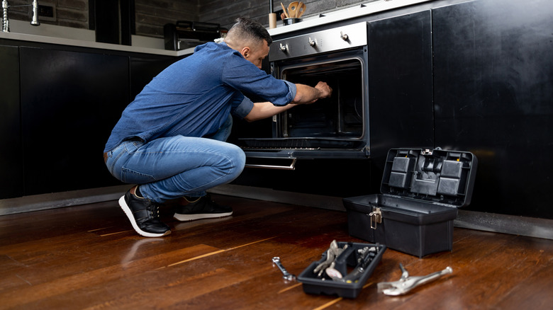 Man fixing oven