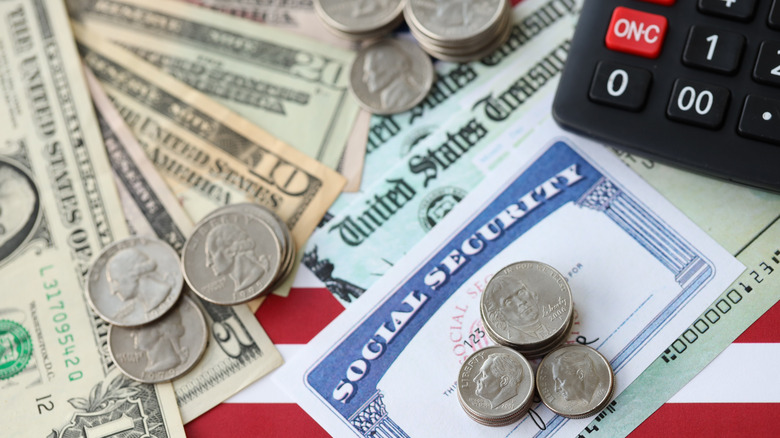 Social security card with cash and a calculator