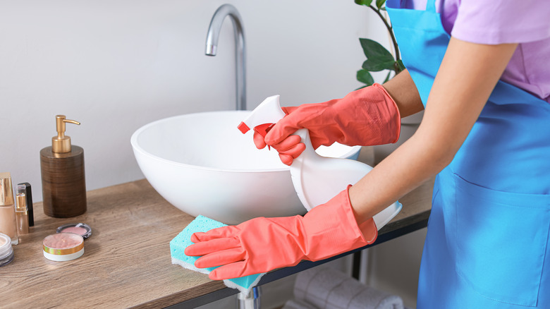 A woman cleaning a bathroom