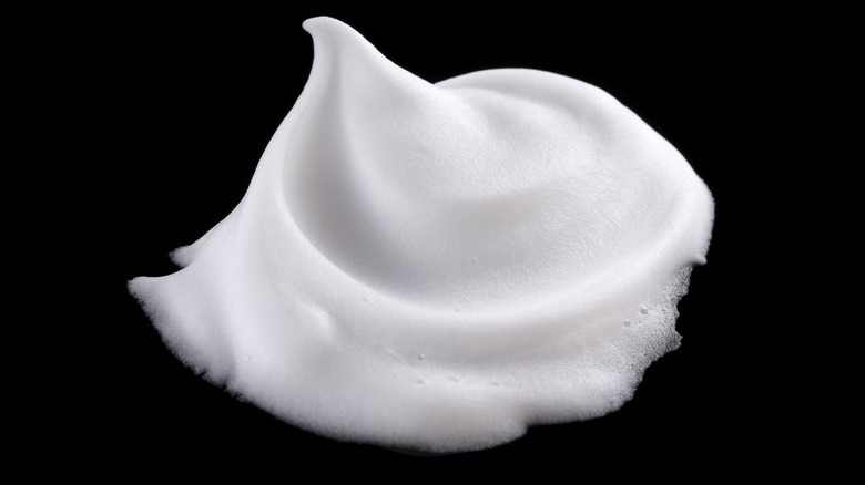 shaving cream on black background