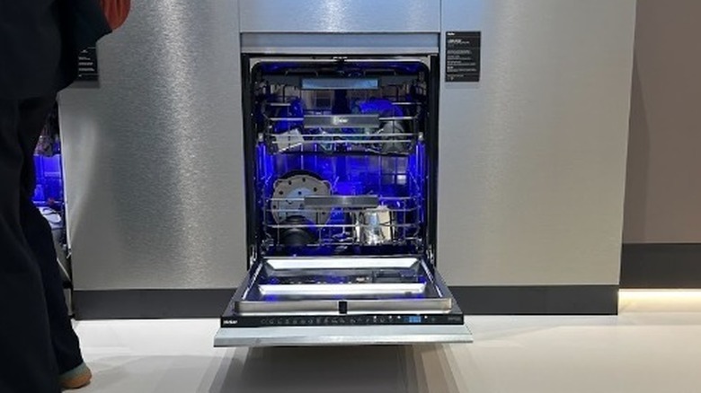 Opened Haier I-Pro Shine dishwasher with LED technology displayed at IFA 2025