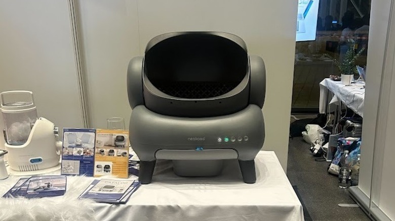 Open-top Neakasa litter robot displayed on top of a white table at IFA 2025