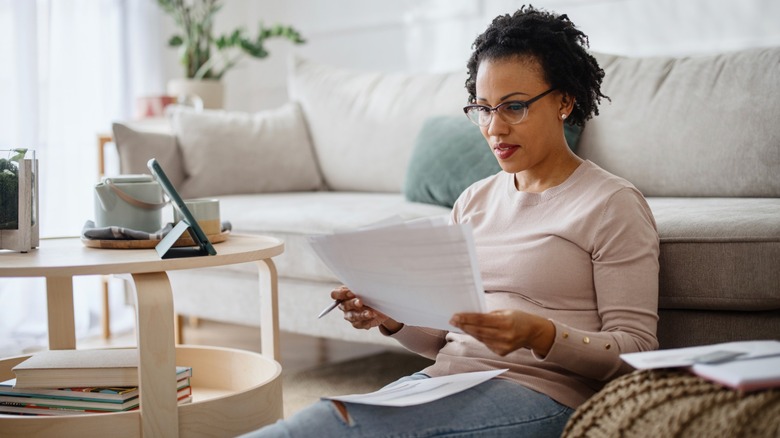 woman reviewing important documents in living room