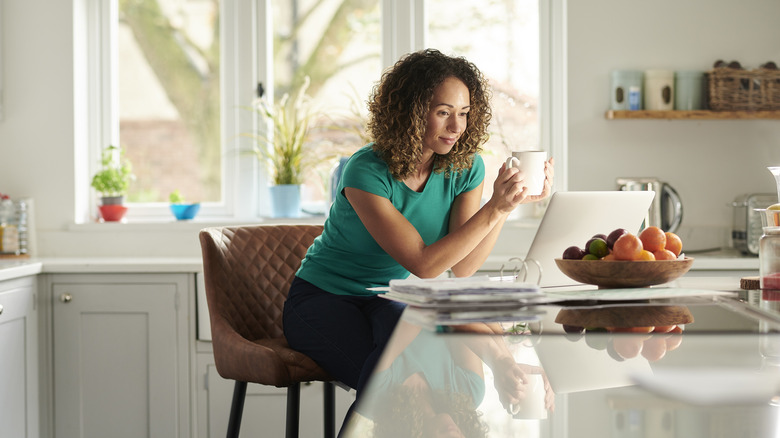 woman on stool at kitchen counter