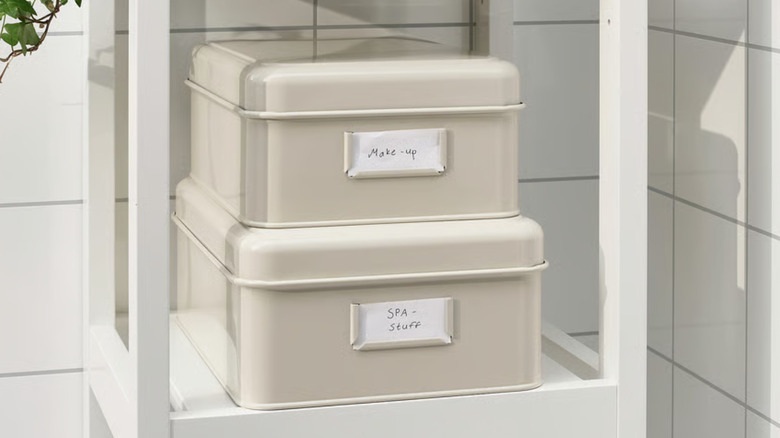 IKEA metal storage containers with labels on a shelf