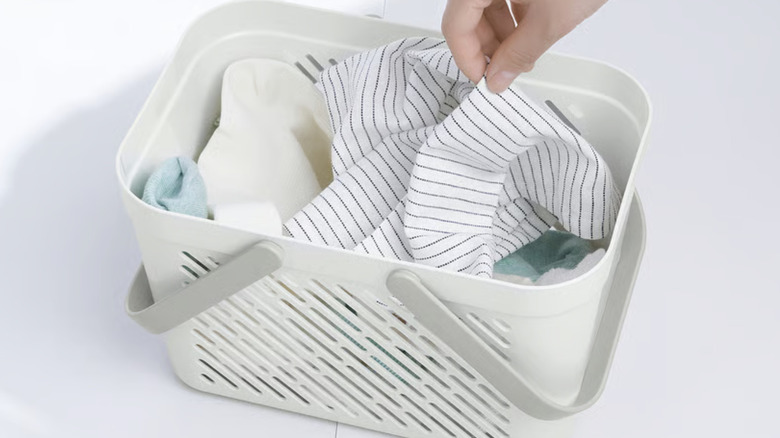 IKEA basket organizers with handles, filled with cloths