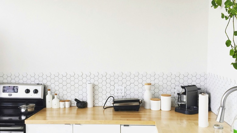 Kitchen with an empty blank wall over counter