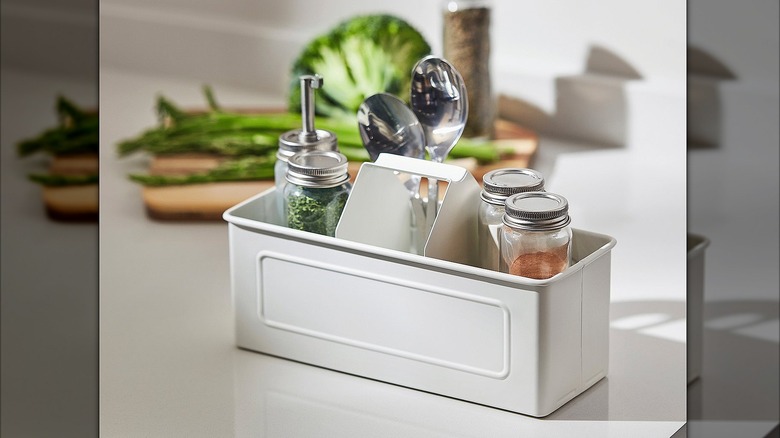 VÄLVÅRDAD on countertop holding jars of spice and spoons