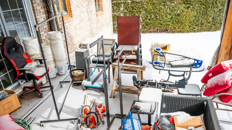 Cluttered patio space with random items on the ground