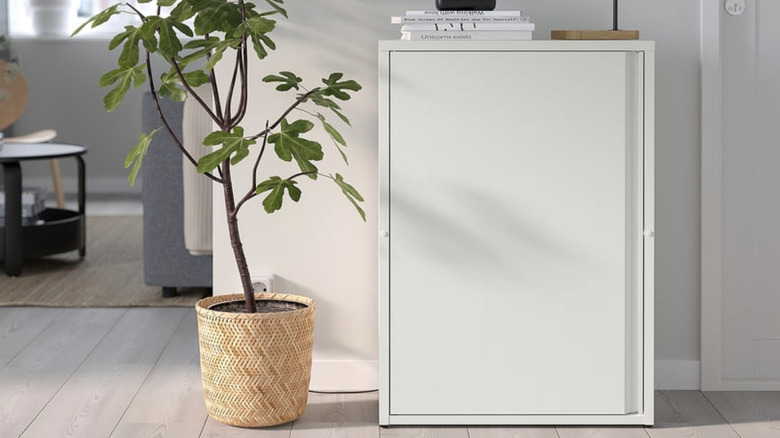 IKEA SUNDSÖ cabinet in off-white in a house with a plant next to it