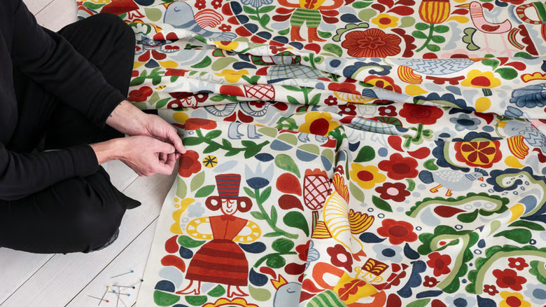 Woman pinning fabric for a sewing project
