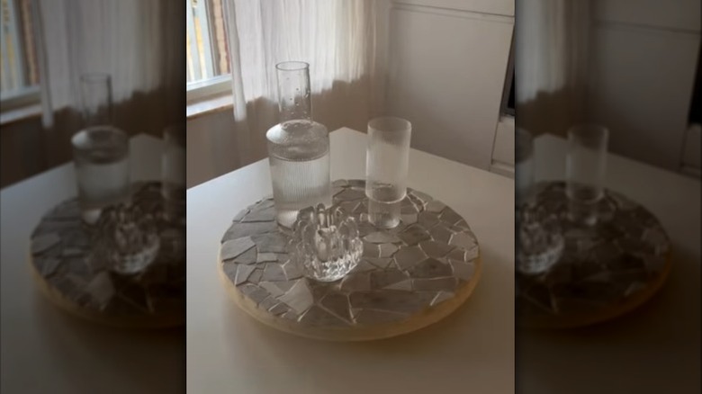 Creator applying broken sample tiles to a SNUDDA to create a mosaic tray