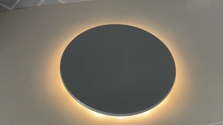 A painted IKEA SNUDDA with lights on the back side sitting on a counter