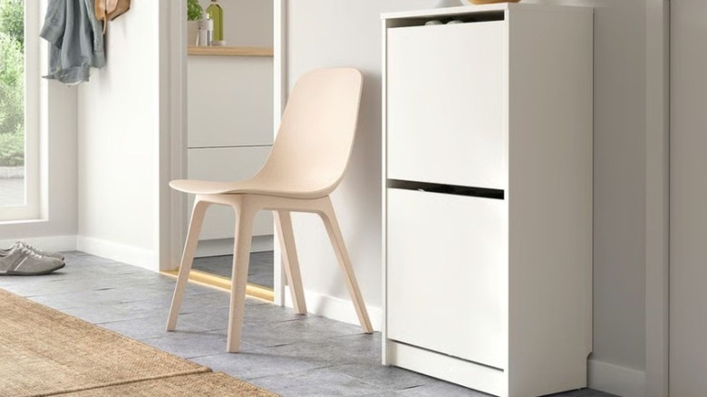 Compact shoe storage sitting next to a chair