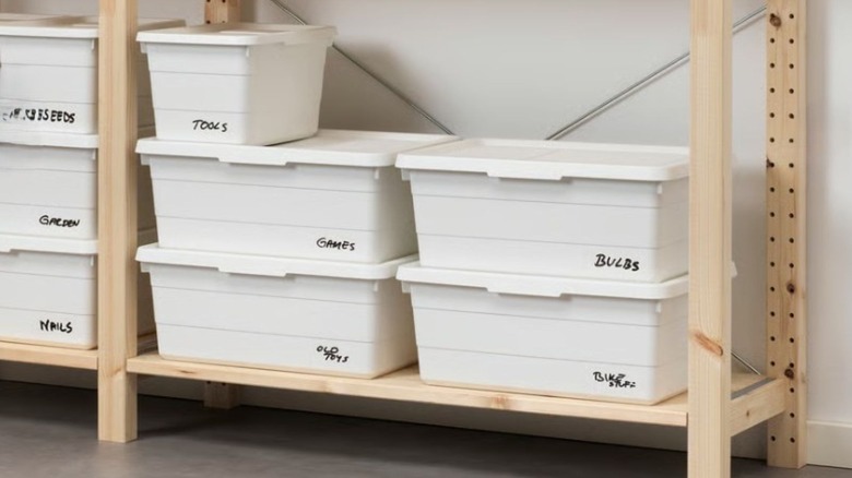 White storage boxes with lids on a wooden shelf
