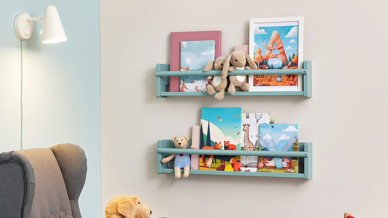 2 of the FLISAT Wall Storage units on the wall with books and stuffed animals stored in the cubby
