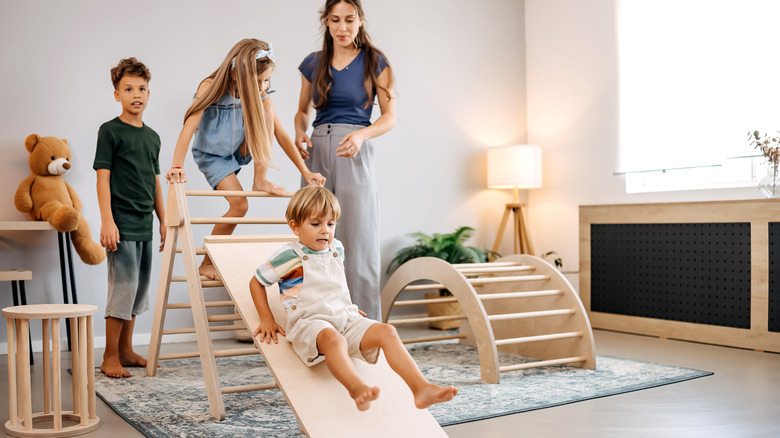 Children playing on indoor Montessori slide