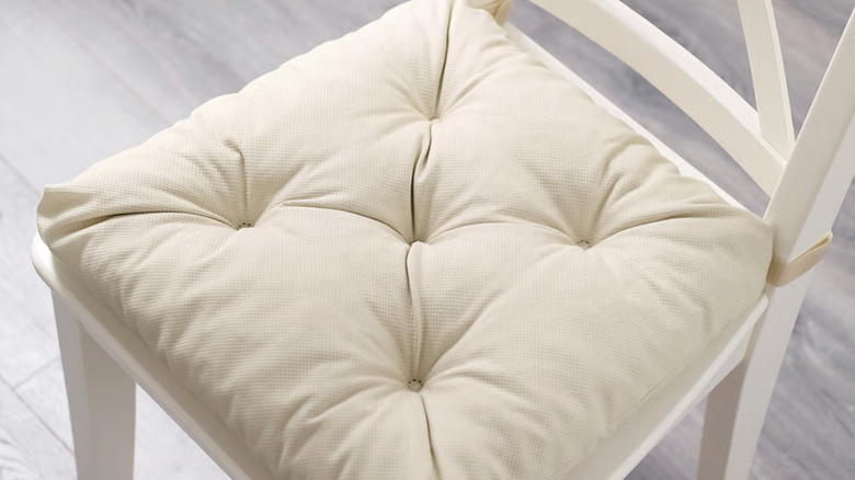 Beige MALINDA chair pad from IKEA on a white chair