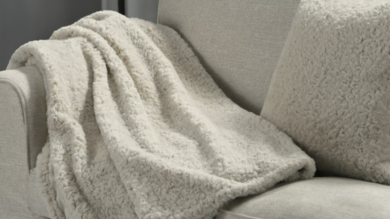 NÄTNÄVA throw from IKEA draped over a beige couch