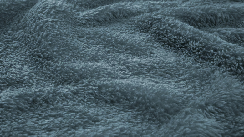 Closeup of TRATTVIVA bedspread from IKEA in blue/green spread out