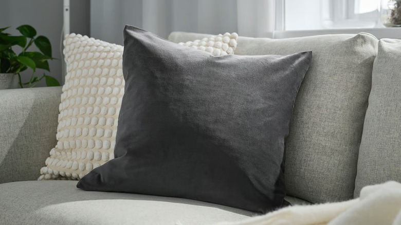 dark gray pillow on a gray couch