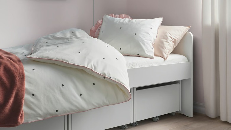 polka dot children's duvet cover on a child's platform bed with storage beneath