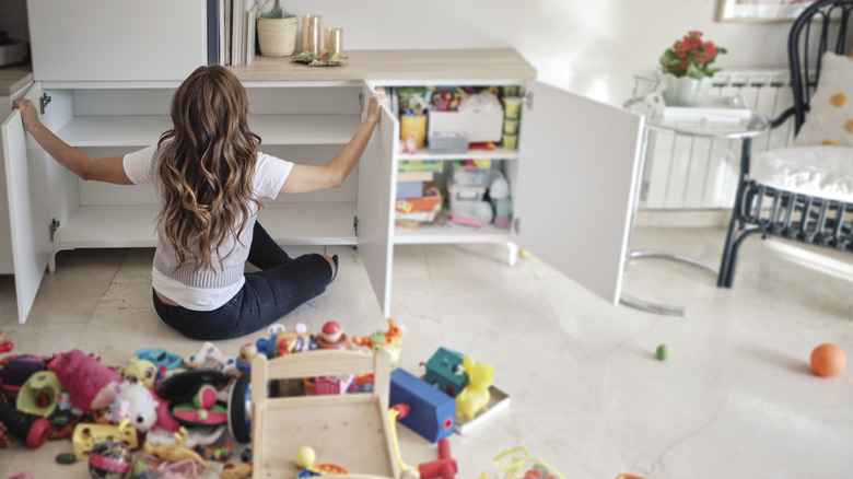 Woman organizing toys in home
