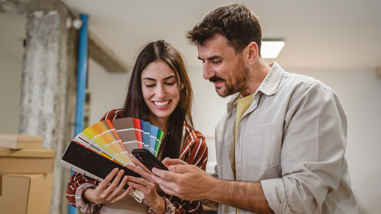 couple looking up paint colors