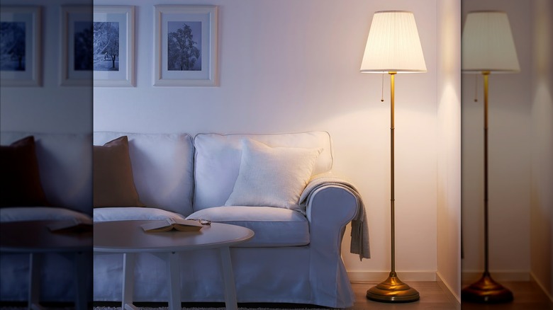 IKEA ÅRSTID floor lamp, turned on, in contemporary styled room