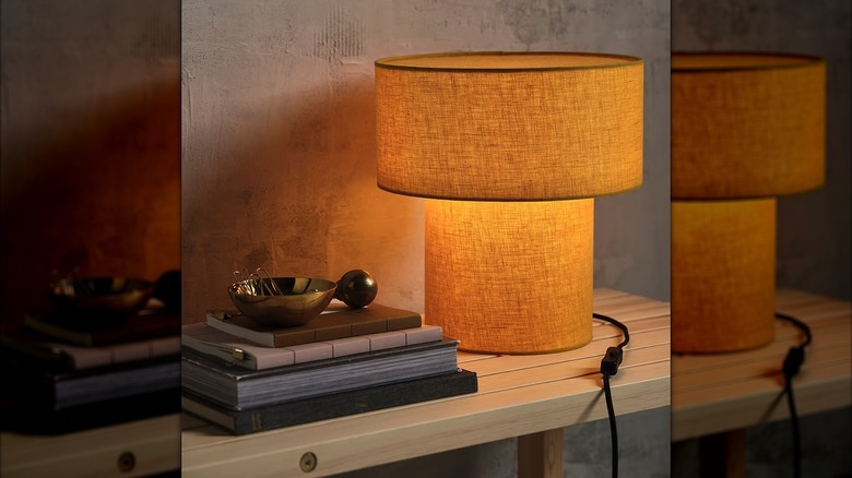 IKEA's sun-yellow linen lamp on a table.