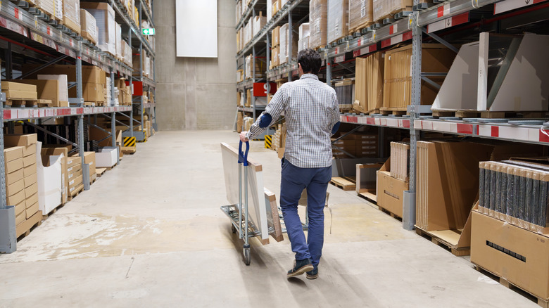 A man shopping in a warehouse of flat packed furniture