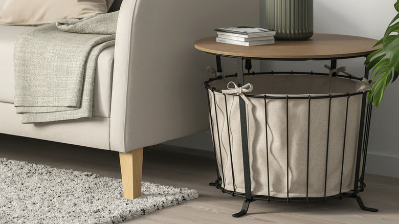 A metal basket with a fabric lining and wood tabletop