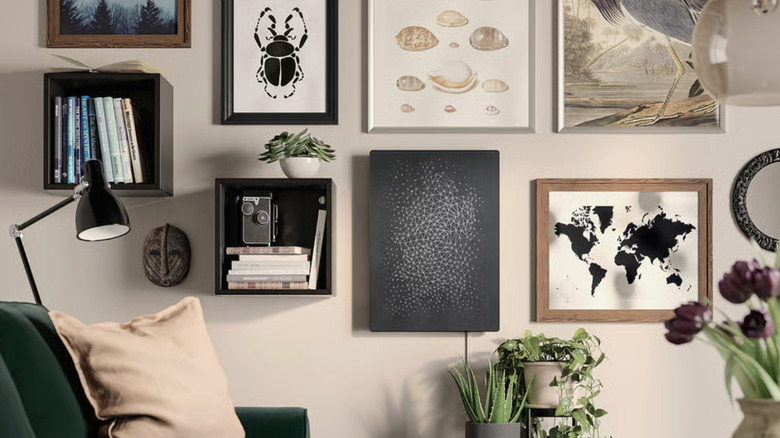 A gallery wall with a flat wall speaker