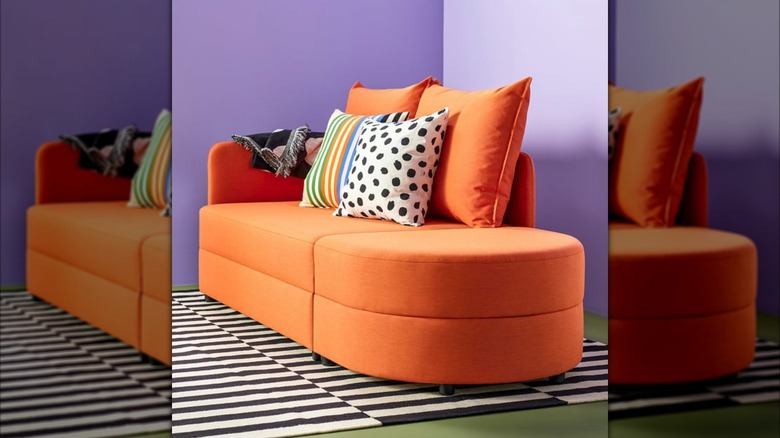Orange IKEA LINDÅKRA in a colorful purple room