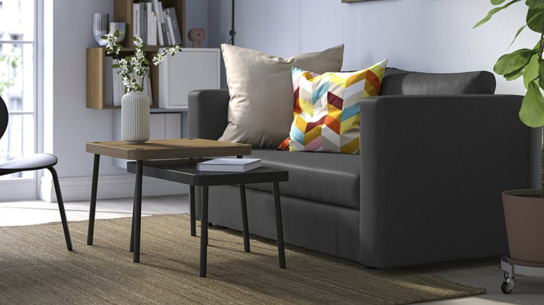 Black IKEA SKÖNABÄCK with colorful cushions