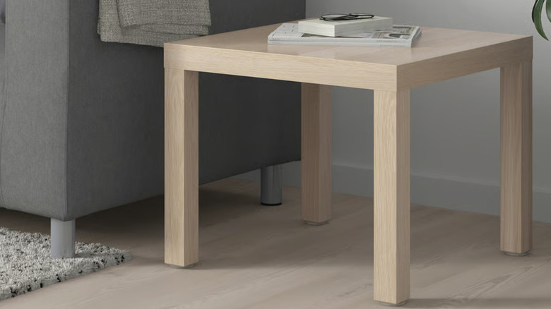 The IKEA LACK side table next to a gray couch