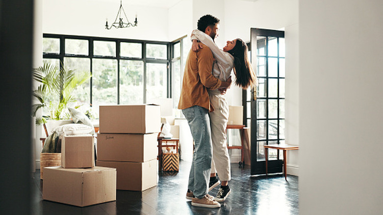 couple hugging in a home with cardboard boxes
