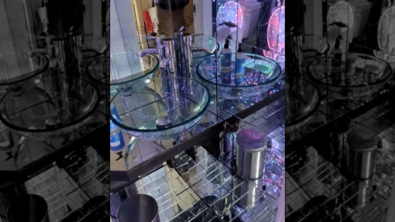 Clear sink bowl in mirrored bathroom