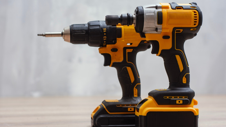 An impact driver and a regular drill side by side