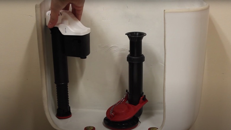person opening toilet fill valve cover