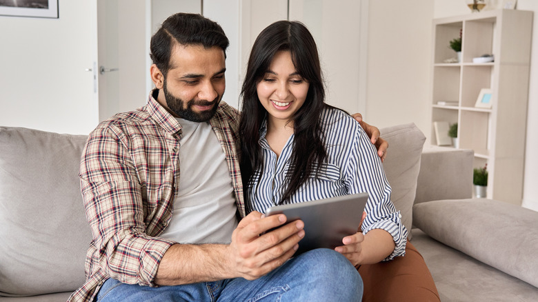 Couple shopping for a home on computer