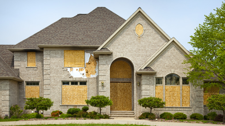 home with boarded windows