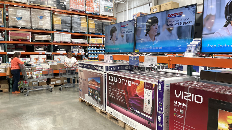 People shopping in Costco near the television aisle