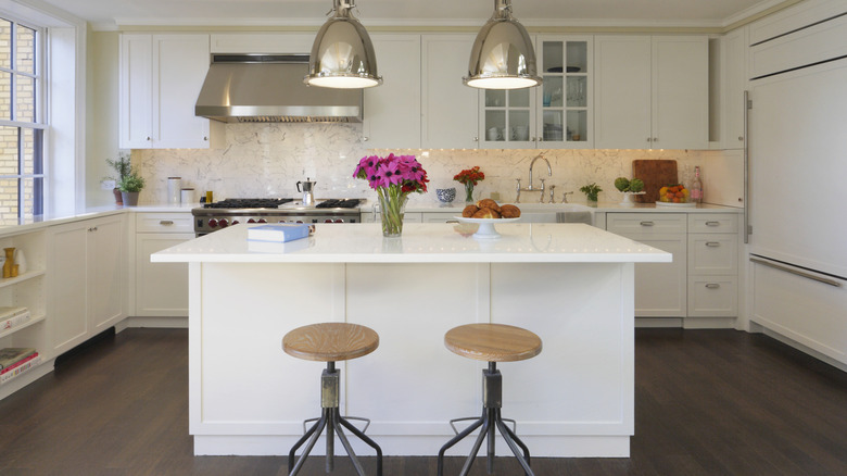 A white island in the middle of an open kitchen