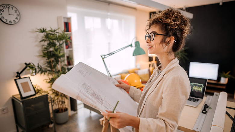 woman holding architectural plans